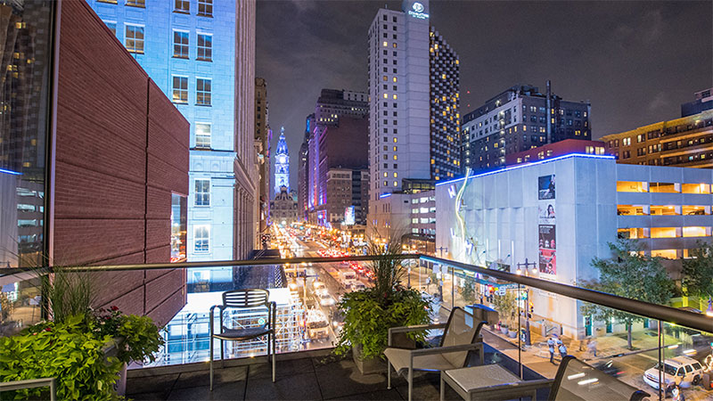Guests step out onto a lovely outdoor balcony overlooking Philadelphia's famous Broad Street.