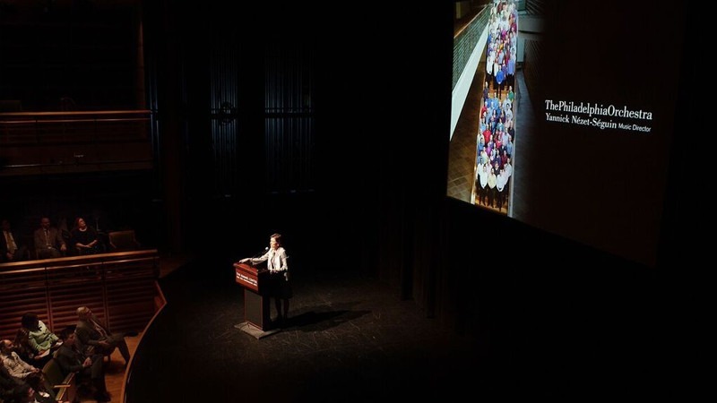 A speech is given to a crowd at the Perelman Theater.