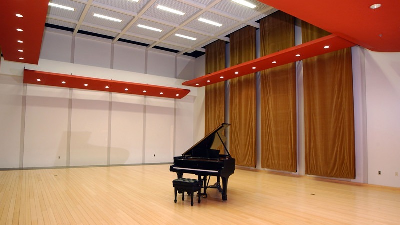 A grand piano sits in the center of the dazzling Rendell Room.