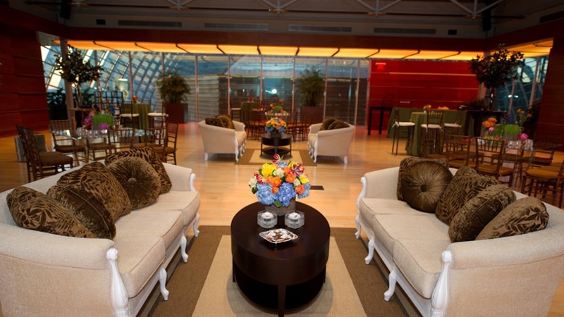 Guests opt for a professional atmosphere with the addition of suede couches and pillows for an event.