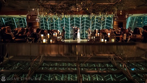 Interior of Hamilton Garden at night with guests sitting and watching the bride and groom