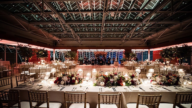 Tables have been arranged to make room for a dance floor in a gorgeous wedding reception.